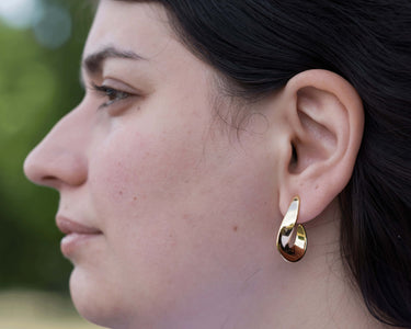 model wearing crescent hoop earrings