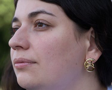 model wearing globe hoop earrings