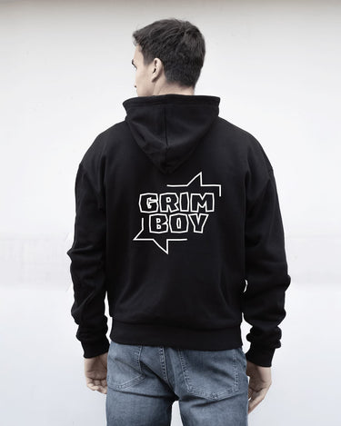 Person wearing a black hoodie with 'GRIM BOY' text on the back against a white background