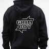 Person wearing a black hoodie with 'GRIM BOY' text on the back against a white background