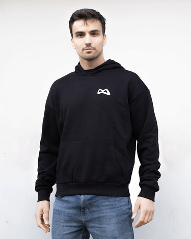 Man wearing a black hoodie with a white grimboy logo