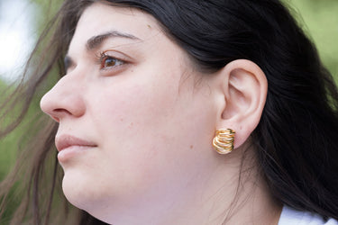 model wearing interlocking loops earrings