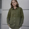 women's olive green linen shirt worn by a model