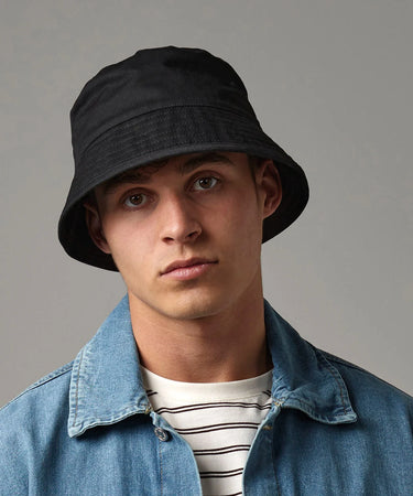 Person wearing a black bucket hat