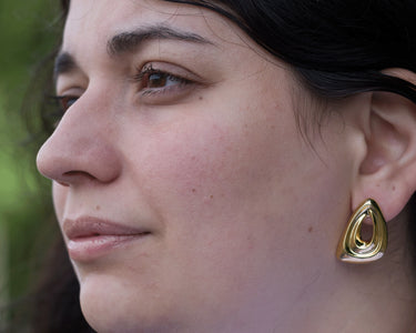 model wearing triangle loop earrings