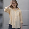women's yellow linen shirt worn by a model